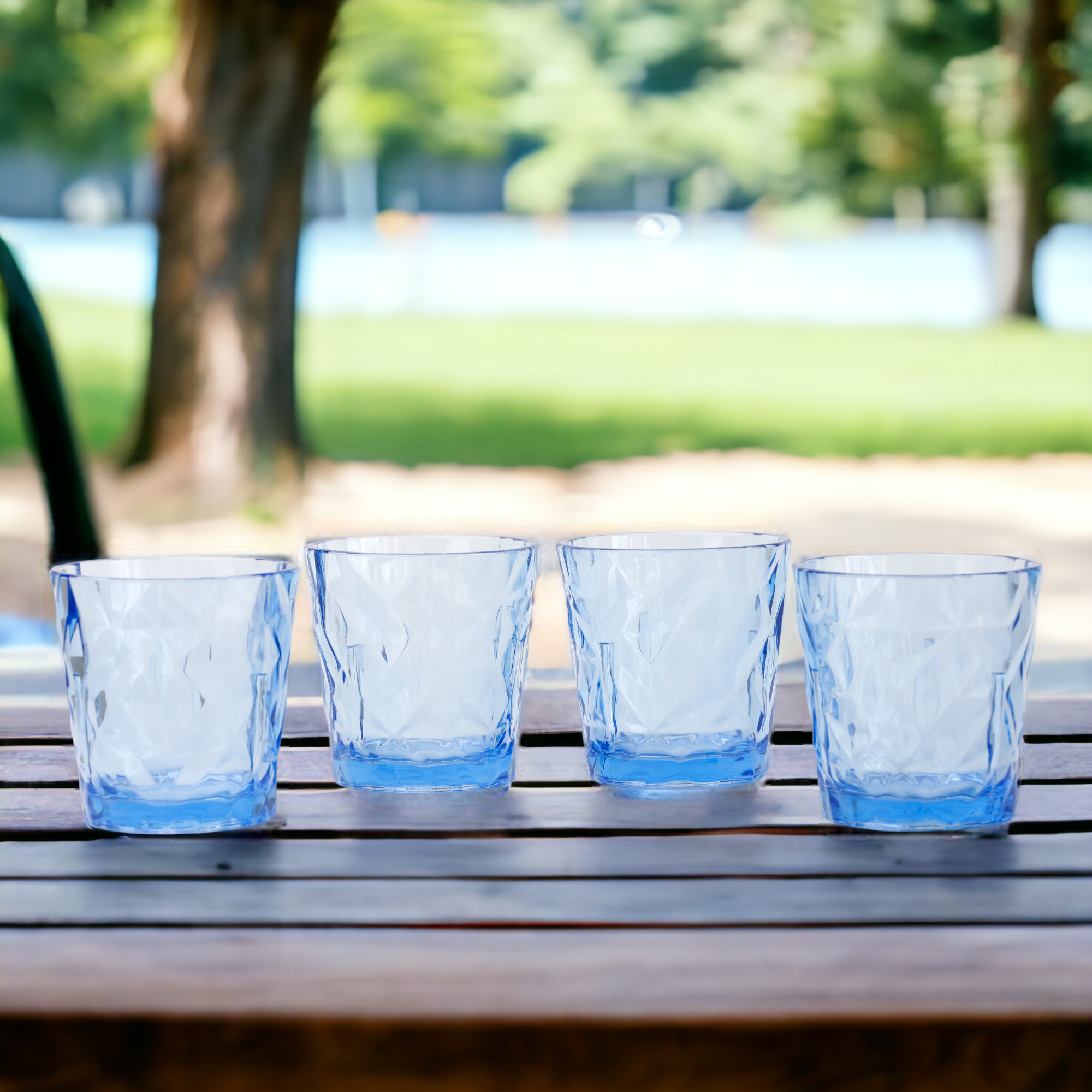 Four clear shatterproof drinking glasses with prism pattern